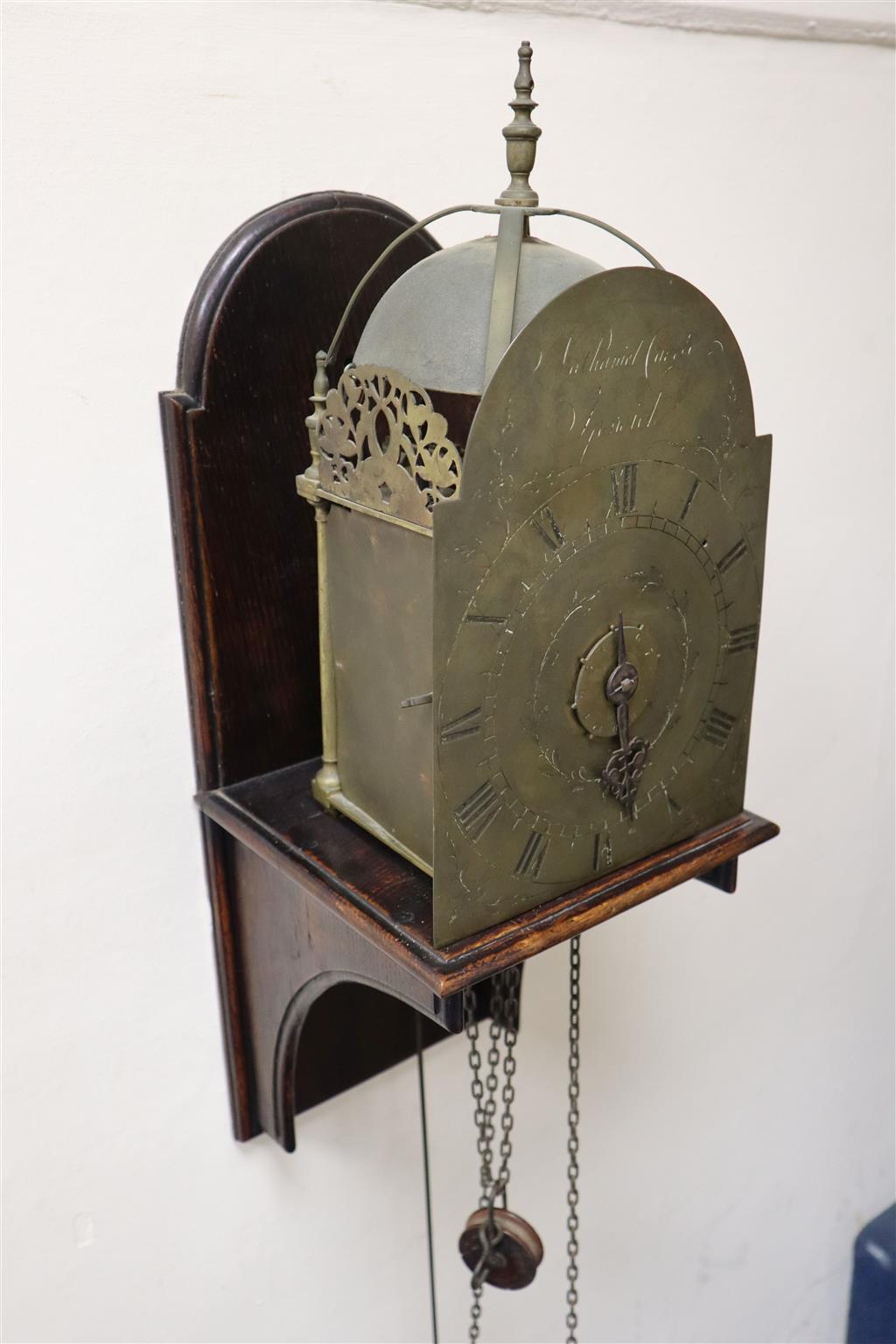 Nathaniel Cavell of Ipswich. A late 18th century brass lantern clock, clock height 13.5in. width 7.5in., overall height of wall bracket